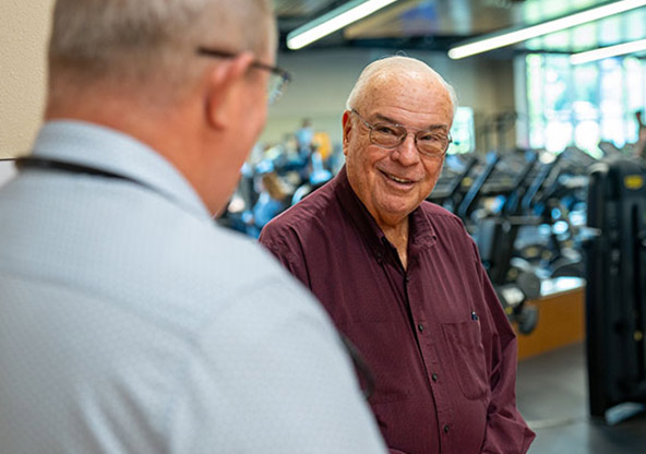 Jim Russell talking to medical staff at CHRISTUS Health after recovering from a heart attack