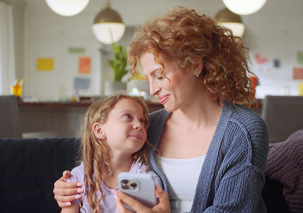 On Demand Care - Mom comforting daughter after receiving On Demand Care on phone 